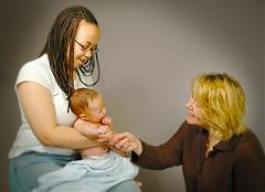 Health care provider with a mother and baby