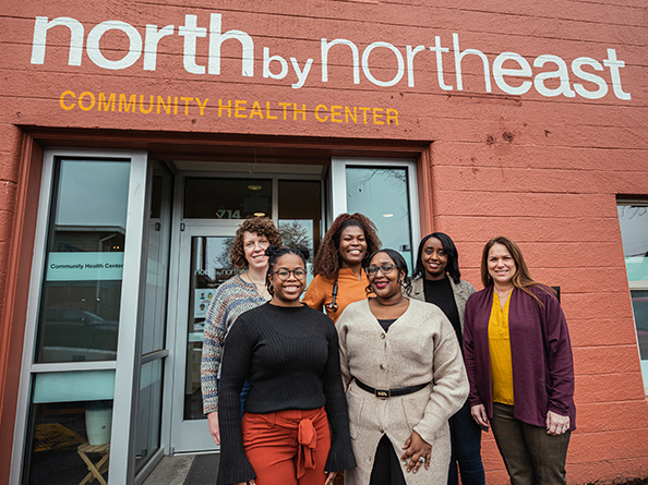 Volunteers standing in front of the North by Northeast Community Health Center