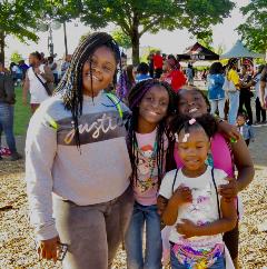 a woman and her younger children in a park