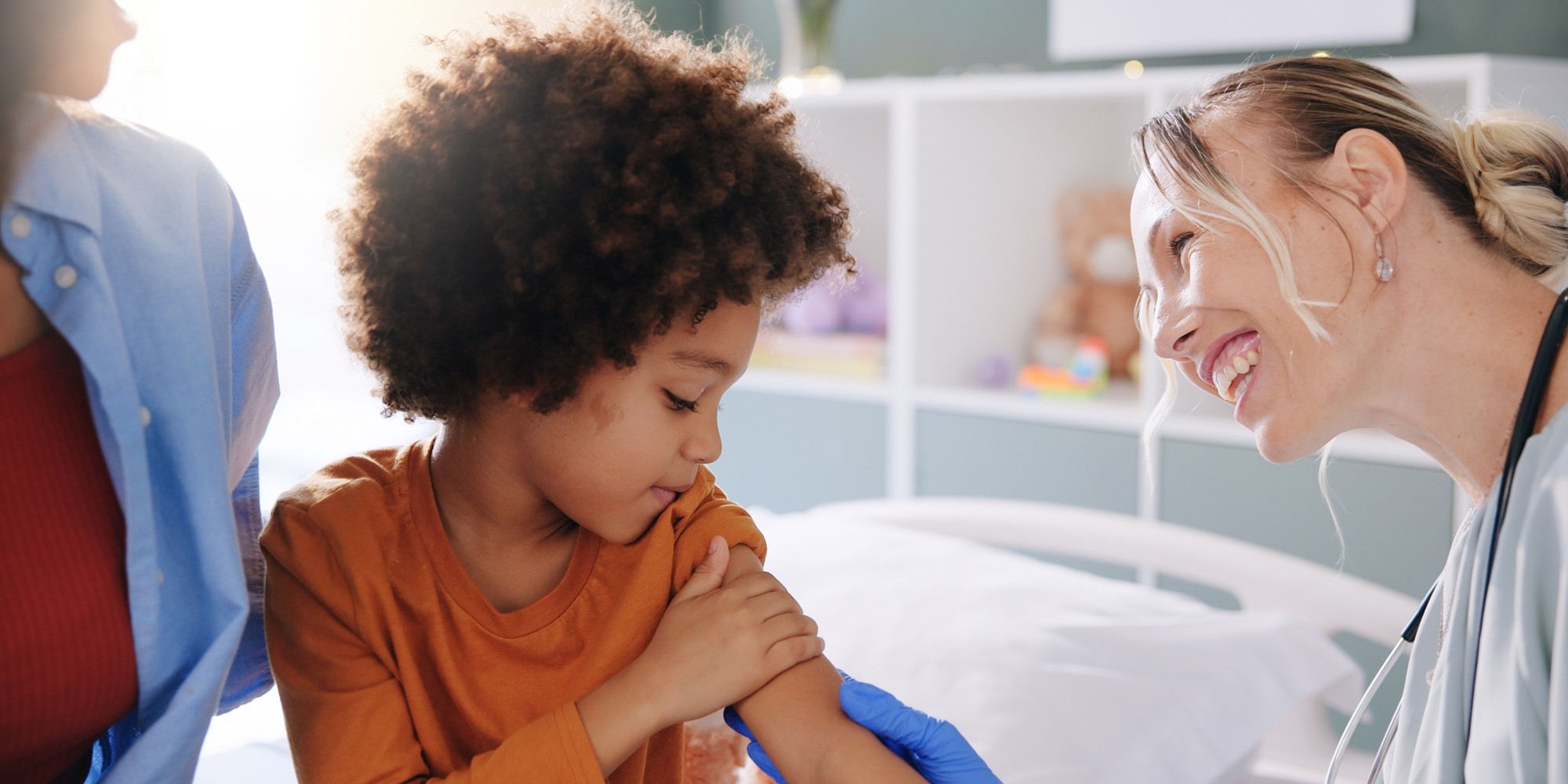 A child getting a flu shot from their doctor