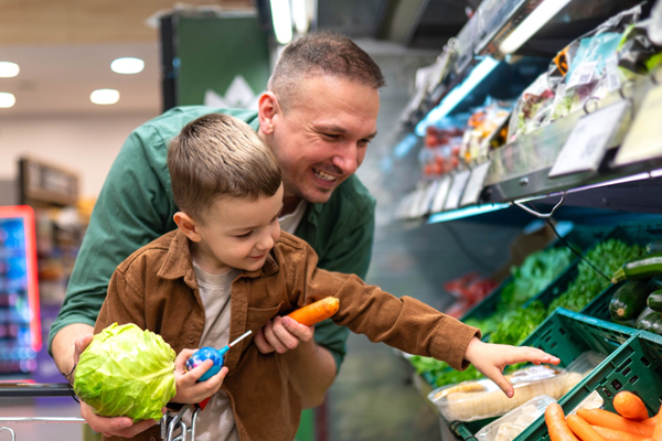 Father shopping at a grocery store with his son
