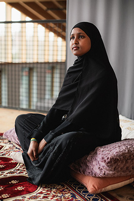 careoregon_ayco_march2025_img018_jasonquigley-story A young woman in a hijab sitting on a coushin